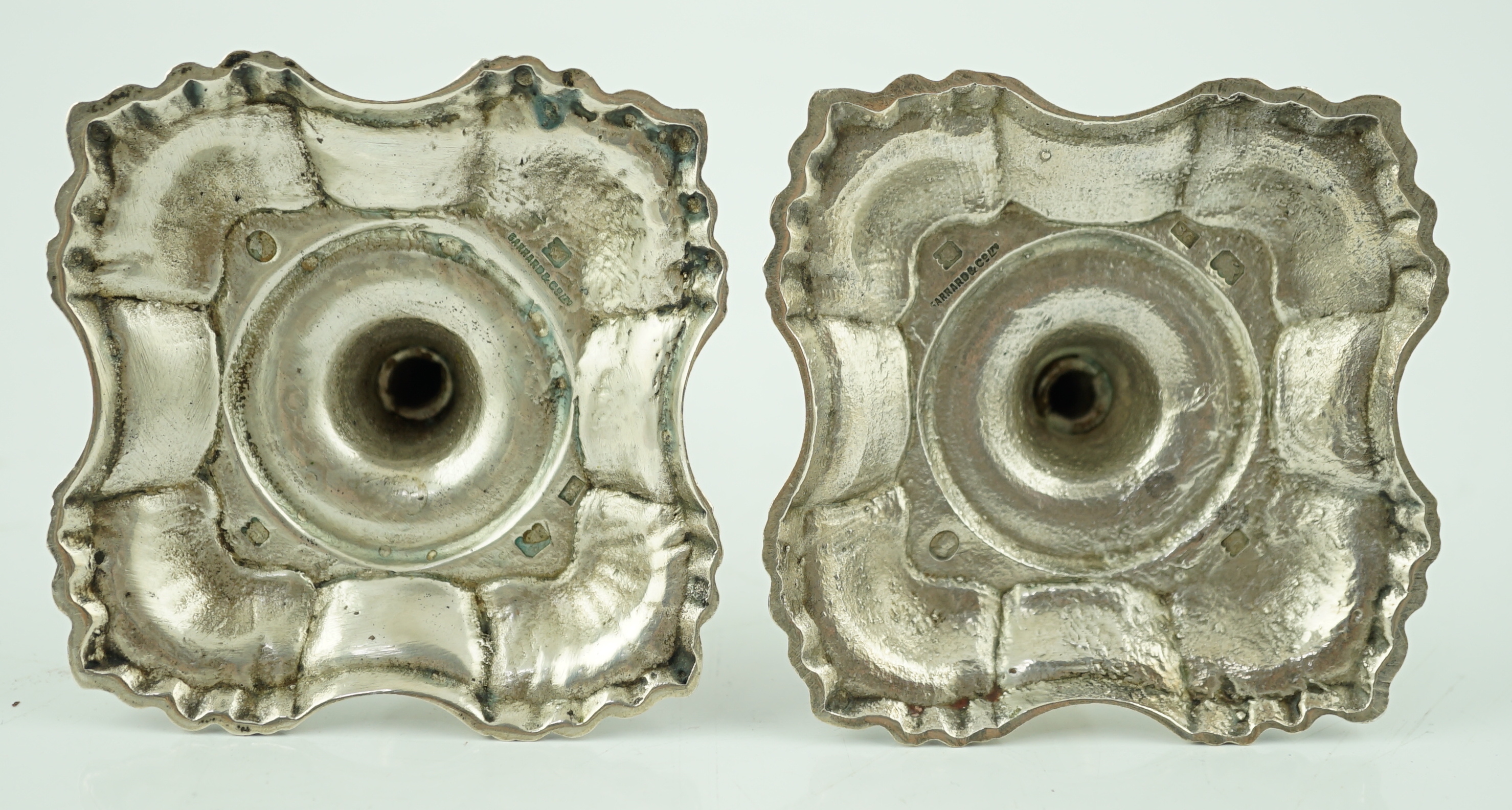 A pair of George V silver tapersticks by Sebastian Garrard for Garrards